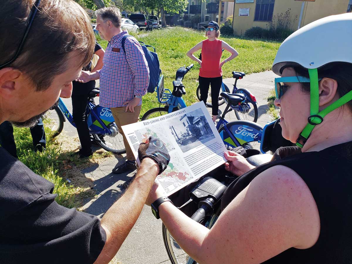 The author pointing out our location on a map of historical redlining