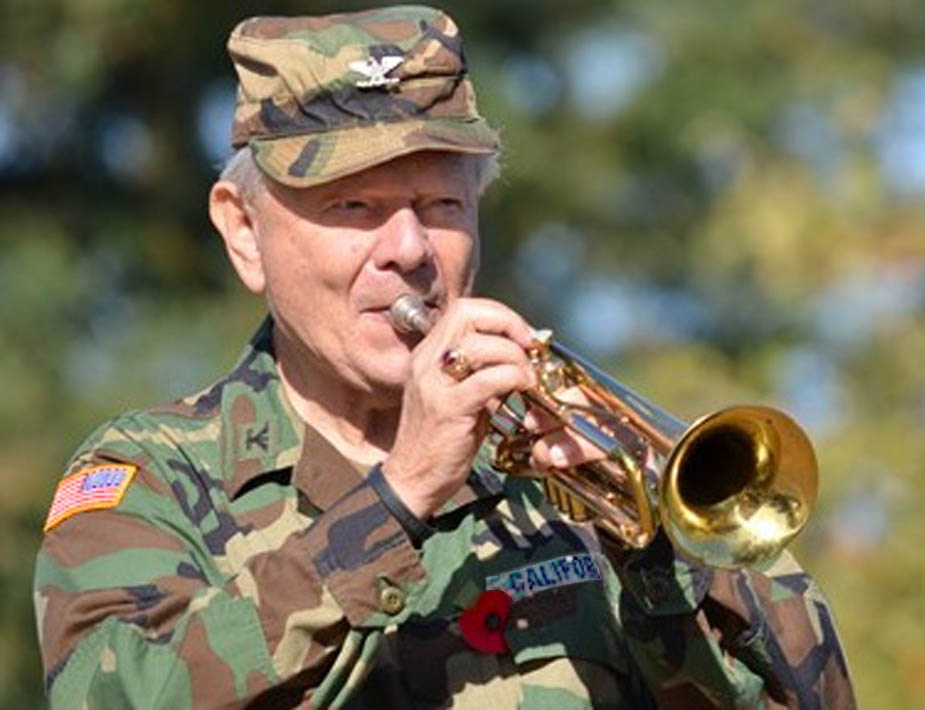 Bird colonel in camo and cap playing trumpet