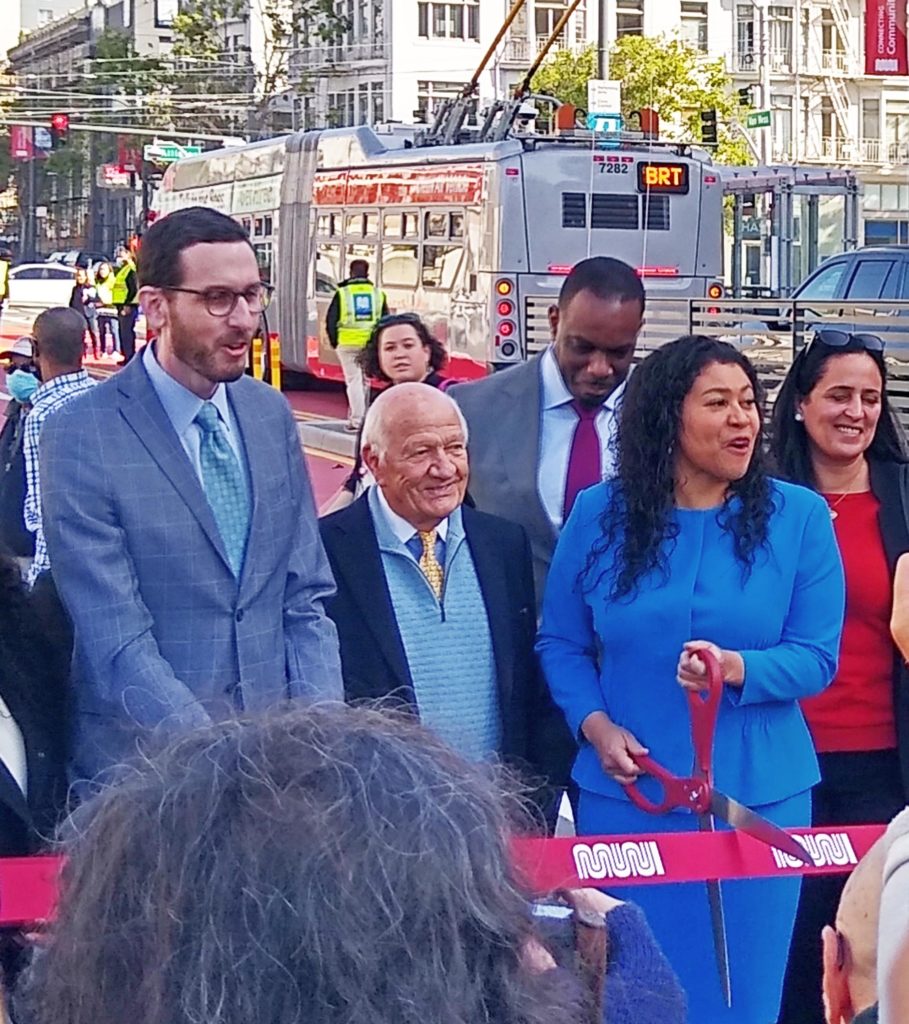 Mayor Breed cuts the ribbon. From the left are State Senator Scott Wiener and Van Ness restaurateur Joe Betz. Photo: Earl Bossard.