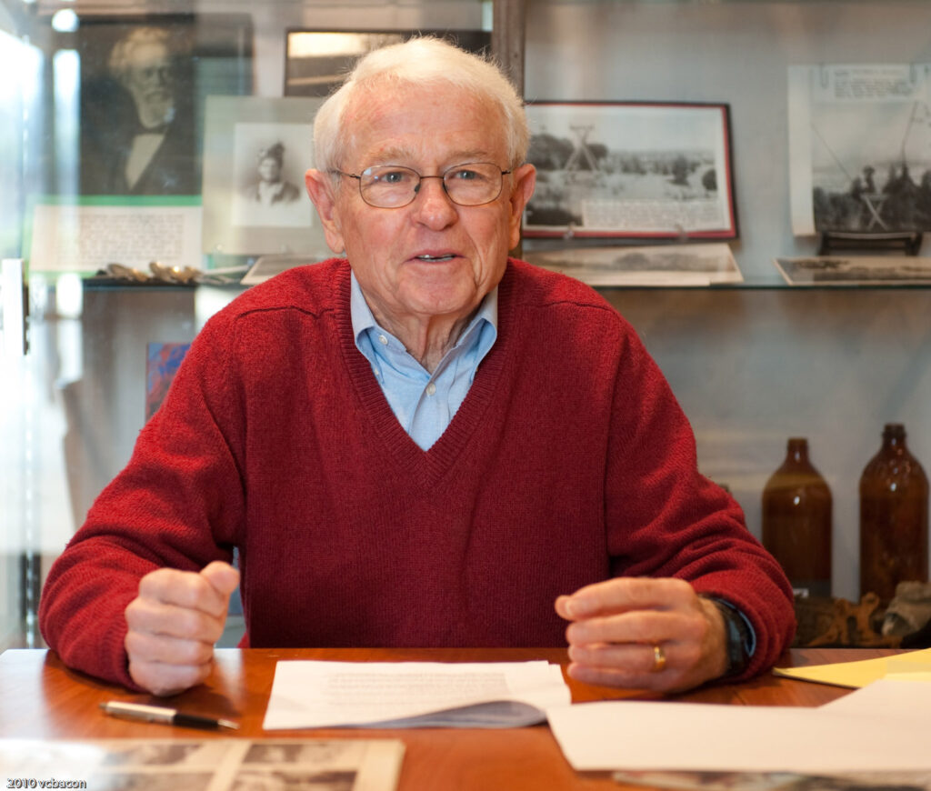 George Mader at desk