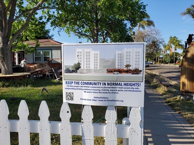 Sign indicating neighborhood opposition to a proposed development project.