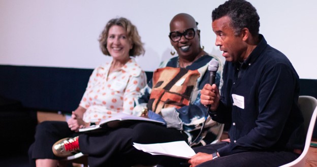 Presenter Robert Ogilvie speaks during the program with other presenters Shannon Jackson and Ashara Ekundayo, observing