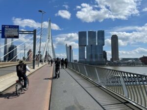 Photo of people riding bicycles across a bridge in the Netherlands.