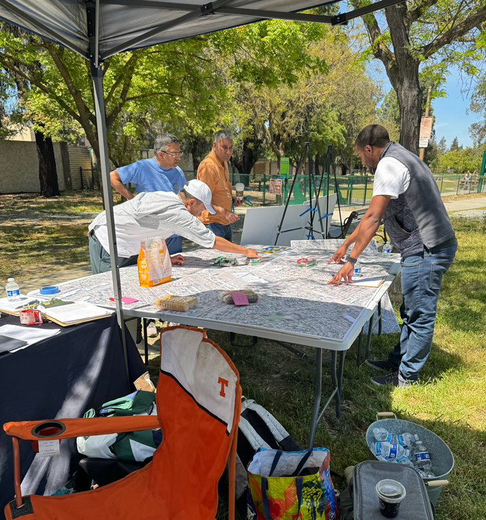 Community members review project maps during West Valley Library pop-up event.