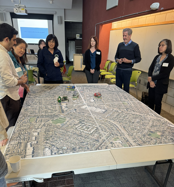 Community members review project maps during West Valley Library pop-up event.