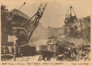 Image from Report on displacement by Bay Area Rapid Transit (BART), May 21, 1966, The Flatlands newspaper collection, MS 197, (African American Museum & Library at Oakland, Oakland Public Library), showing a construction worker clearing debris after demolishing houses to clear a path for I-980.