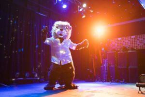 full screen) Monty_dance.jpg
ALT TEXT: Monte Rey, the otter mascot for the 2025 APA California Conference, dances under colorful stage lights in a white shirt at the Northern Section Awards Gala.