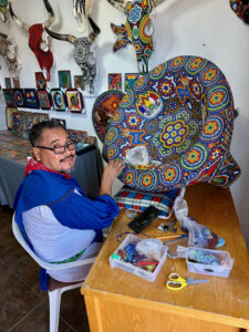Picture of an working artist taken by a tourist passing by in the town of Todos Santos, Baja California Sur, Mexico.