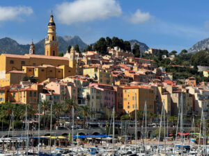 Image of Old Town, Menton, France, with Roman architecture in the background and sailing vessels in the foreground.