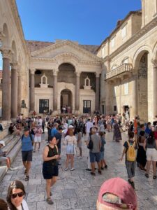 Image of Diocletian's Palace courtyard filled with tourists in Split, Croatia.