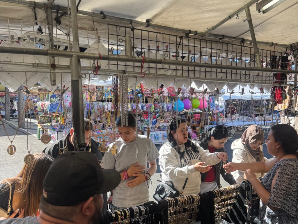 Engaging with Vendors_resized Customers inquiring about products, from the perspective of the vendor’s side of the stall.