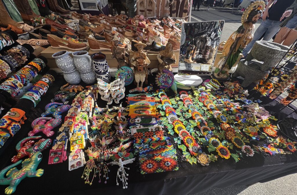 MarketGoods Beaded handicrafts, cultural items, shoes, and ceramics displayed at the market.