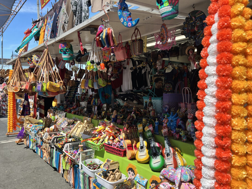 VibrantGoods Vibrant stall selling handbags, guitars, toys, and handcrafted goods.