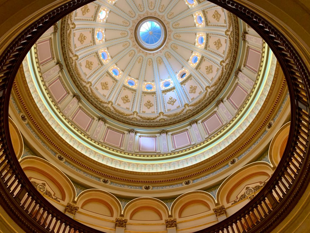 Intricate dome ceiling at the California State Capitol building in Sacramento, showcasing ornate design and architecture.