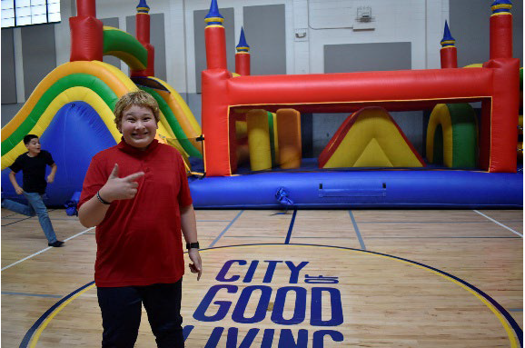 San Carlos Youth Center gym event_credit-City of San Carlos Colorful photo of a woman at a youth center in San Carlos, California.